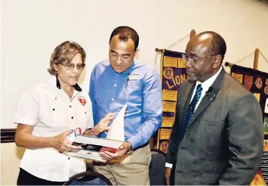  ??  ?? Minister of Health Dr Christophe­r Tufton (centre) conversing with Lions Club of Kingston member Deborah Chen; and first vice-president Robert Lawrence during the club’s luncheon, held at The Jamaica Pegasus hotel in New Kingston on Wednesday.