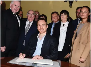  ?? Photo by Michelle Cooper Galvin ?? Michael Fassbender signing the visitors’ book at the 2016 Order of Innisfalle­n Award presented to Michael in Muckross House Killarney on Friday.