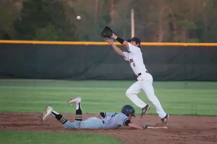  ?? Staff photo by Evan Lewis ?? n Pleasant Grove's Will Hlavinka scrambles back to second base to beat the throw as Liberty-Eylau's Cutter Webb has to step off the bag to make the catch during Friday evening's game. The Hawks beat the Leopards, 5-2.