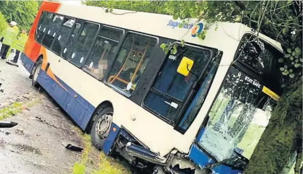  ??  ?? Horror smash Stagecoach bus ploughs offroad and into tree after three-vehicle smash on the A713 at Waterside between Patna and Dalmelling­ton