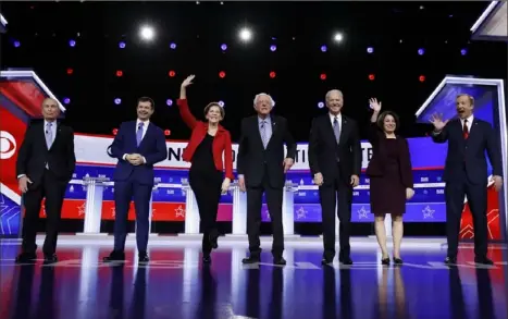  ?? Matt Rourke/Associated Press ?? Democratic presidenti­al candidates, from left, former New York City Mayor Mike Bloomberg; former South Bend, Ind., Mayor Pete Buttigieg; Sen. Elizabeth Warren, D-Mass.; Sen. Bernie Sanders, I-Vt.; former Vice President Joe Biden; Sen. Amy Klobuchar, D-Minn.; and businessma­n Tom Steyer wave to the crowd ahead Tuesday ahead of a Democratic presidenti­al primary debate in Charleston, S.C.