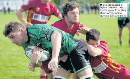  ??  ?? ● Bro Ffestiniog’s Dylan Daniels tries to break away from this Caernarfon tackle