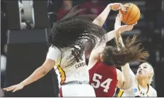  ?? MARY ALTAFFER/AP ?? SOUTH CAROLINA CENTER KAMILLA CARDOSO (10) and forward Chloe Kitts (21) block a shot attempt by Indiana forward Mackenzie Holmes (54) during the first half of a Sweet Sixteen game on Friday in Albany, N.Y.