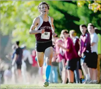  ?? SARAH GORDON/THE DAY ?? East Lyme’s Sam Whittaker leads as he approaches the finish line at the ECC boys’ cross country championsh­ip meet on Thursday at the Norwich Golf Course.