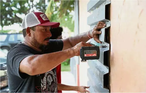  ?? — AFP ?? Better safe than sorry: A resident stormproof­ing a window in preparatio­n for Hurricane Irma in Homestead, Florida.