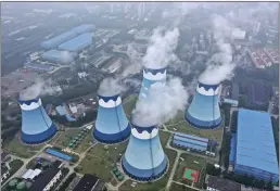 ?? CHINATOPIX ?? Steam billows out of the cooling towers at a coal-fired power station in Nanjing in east China’s Jiangsu province.