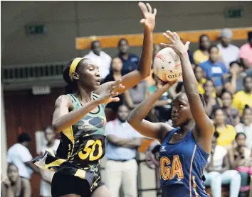  ??  ?? Jamaica’s goal defence Jodi-Ann Ward (left) tries to prevent Barbados goal attack Sheniqua Thomas from shooting a shot during second quarter of their third Test series at the National Arena on Monday.