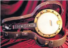  ??  ?? The John E. Dallas ‘Special Model E’ banjolele made for George Formby, right, in the 1930s which was later bought by Beatles guitarist George Harrison