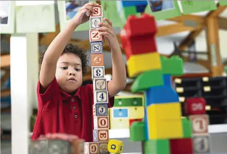  ??  ?? Experts are encouragin­g that children play with building blocks, like in this file picture, as it develops their maths skills.
