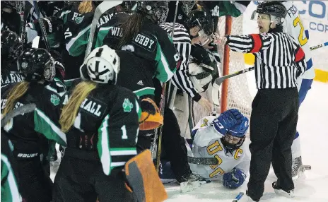  ?? PHOTOS: KAYLE NEIS ?? Thunderbir­ds’ Celine Tardif lays on the ice as the University of Saskatchew­an Huskies celebrate their win against the University of British Columbia at Rutherford Rink on Saturday. The women swept the best-of-three Canada West semifinal. sending the...