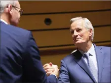  ?? VIRGINIA MAYO — THE ASSOCIATED PRESS ?? European Union chief Brexit negotiator Michel Barnier, right, shakes hands with Irish Foreign Minister Simon Coveney during a meeting of EU General Affairs ministers, Article 50, at the European Convention Center in Luxembourg, Tuesday. European Union chief Brexit negotiator Michel Barnier is in Luxembourg on Tuesday to brief ministers on the state of play for Brexit.