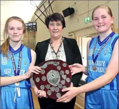  ??  ?? Joint captains Kirsten Kenny and Sinéad Curran receiving the shield from Theresa Walsh, President of Basketball Ireland.