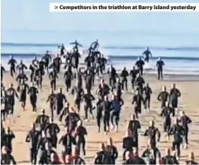  ??  ?? > Competitor­s in the triathlon at Barry Island yesterday