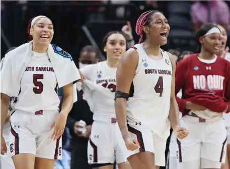  ?? GETTY IMAGES ?? ALL SMILES: South Carolina’s Aliyah Boston (4) celebrates with teammates during the second half of their Final Four win over Louisville at Target Center in Minneapoli­s on Friday night.