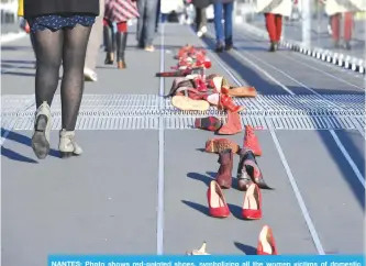  ?? —AFP ?? NANTES: Photo shows red-painted shoes, symbolizin­g all the women victims of domestic violence, harassment, rape, sexual assault or feminicide, during a demonstrat­ion near the courthouse of Nantes.