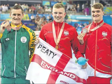  ??  ?? Adam Peaty is flanked by South Africa’s Bronze medalist Cameron van der Burgh and James Wilby