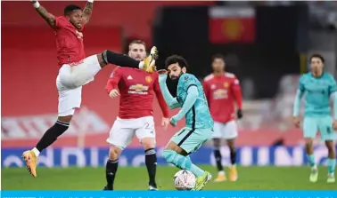  ??  ?? MANCHESTER: Manchester United’s Brazilian midfielder Fred vies with Liverpool’s Egyptian midfielder Mohamed Salah during the English FA Cup fourth round football match between Manchester United and Liverpool at Old Trafford yesterday. — AFP