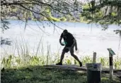  ??  ?? A disc golfer tees off at Bill Frederick Park at Turkey Lake.