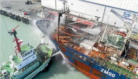  ?? PHOTOS: JOHN BISSET/STUFF ?? The fishing vessel Dong Won 701 was still smoking as firefighte­rs continued efforts to extinguish two fires on Friday.