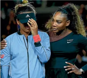  ?? GETTY IMAGES ?? Williams comforts Japan’s Naomi Osaka as the crowd boos during the trophy presentati­on after the final won by Osaka.