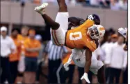  ?? (AP/Wade Payne) ?? Tennessee running back Jaylen Wright (0) is upended by a Texas A&M defender Saturday in Knoxville, Tenn. Wright rushed for 136 yards, more than the Volunteers passing offense could muster, in a narrow 20-13 win over the Aggies.