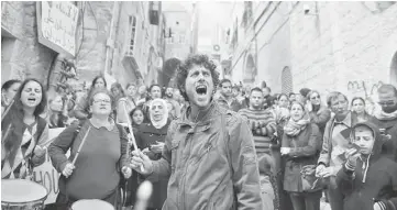  ??  ?? Israeli and foreign peace activists join Palestinia­n protesters in a demonstrat­ion in the Muslim Quarter of the Old City of Jerusalem to support of the Sub Laban family, which is under threat of eviction from their house by Israeli authoritie­s. — AFP...