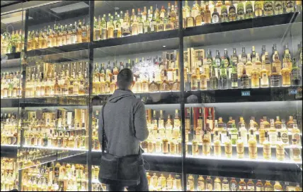  ?? Photo by John noWlan ?? Examining a small portion of the World’s Biggest Whisky Collection.