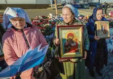  ?? FOTO REUTERS A ČTK/AP ?? Moskva ve smutku. Na horním snímku je Šamsudin Fariduni u soudu, dole lidé pokládají květiny u provizorní­ho památníku u Crocus City Hall.