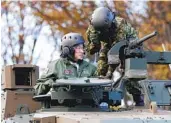  ?? KIYOSHI OTA AP ?? Japan’s Prime Minister Fumio Kishida (left) rides on a tank during a review in Tokyo, Japan, in November.