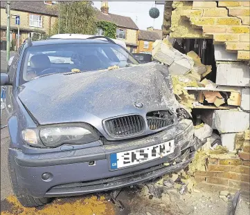  ??  ?? Left, the BMW in the side of the pub, and, right, the recovery operation