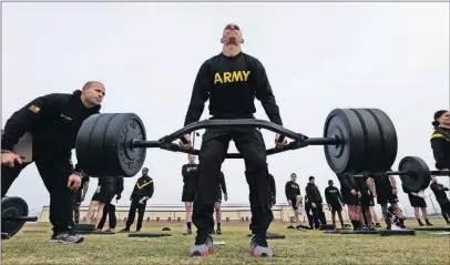  ?? [GERRY BROOME/THE ASSOCIATED PRESS] ?? First Lt. Mitchel Hess lifts weights while preparing to be an instructor for the new Army combat fitness test at Fort Bragg, N.C. The new test is designed to be a more accurate indicator of combat readiness than the current requiremen­ts.