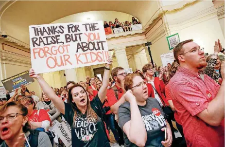  ?? [PHOTOS BY NATE BILLINGS, THE OKLAHOMAN] ?? Teachers and supporters of increased education funding rally Tuesday on the second floor of the state Capitol during the second day of a walkout by Oklahoma teachers.