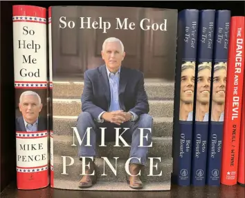  ?? Justin Sullivan/Getty Images ?? Copies of the new book “So Help Me God” by former U.S. Vice President Mike Pence are displayed on a shelf at a Barnes & Noble bookstore Tuesday in Corte Madera, Calif. The new autobiogra­phy by former VP Mike Pence hit bookstore shelves Tuesday.