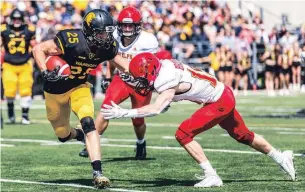  ?? JON HALPENNY ?? Warriors’ Tyler Ternowski (25) evades a Guelph Gryphons tackler last September in an OUA football game in Waterloo. Ternowski is expected to be selected in Thursday’s CFL draft.