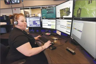  ?? (NWA Democrat-Gazette/Flip Putthoff) ?? Desiree Beaver looks at informatio­n while on duty Tuesday in the communicat­ions center at the Bentonvill­e Police Department. A new radio system for the department is part of a $266 million bond issue residents will vote on April 13.