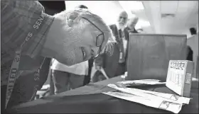  ?? Arkansas Democrat-Gazette/THOMAS METTHE ?? Dr. J. Gary Wheeler checks out a box of syringes in a time capsule opened Friday at the state Health Department in Little Rock.