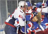  ?? Bruce Bennett / Getty Images ?? The Capitals’ Tom Wilson takes a roughing penalty during the second period against the Rangers’ Artemi Panarin at Madison Square Garden on Monday.