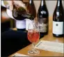  ?? NHAT V. MEYER — STAFF ?? Bar manager Daniel Martinez serves wine at San Jose's Goodtime Bar, which specialize­s in natural wine.