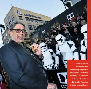  ??  ?? Peter Mayhew with fans (and stormtroop­ers) at the Star Wars: The Force Awakens LA premiere in December 2015. Below: In Chewie’s shaggy-rug costume.