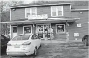  ?? [STEVEN BITTNER/CUMBERLAND TIMESNEWS VIA THE ASSOCIATED PRESS] ?? In this Thursday photo, a patron approaches the entrance to Coney Market, a convenienc­e store in Lonaconing, Md., where the jackpot-winning Powerball ticket worth $731.1 million was sold in a struggling coal mining town whose biggest previous claim to fame was being the hometown of baseball legend Lefty Grove. The store will receive a $100,000 bonus from the Maryland Lottery for selling the ticket to the fifth-largest lottery prize in U.S. history.