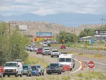  ?? JUSTIN HORWATH THE NEW MEXICAN ?? Southbound drivers exit Interstate 25 at Algodones on Tuesday after the freeway was blocked following a midmorning police chase and shooting. No one was injured in the shooting, and the chase suspect was taken into custody. The road reopened in time...