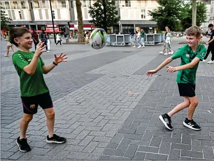  ?? ?? BOYS IN GREEN: Robert Lewis
(left) from Laois and Scott Cook from Tipperary pass the time in Nantes