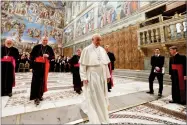  ?? ANDREW MEDICHINI ?? Pope Francis leaves after taking a family photo with diplomats accredited to the Holy See inside the Sistine Chapel, at the end of an audience for the traditiona­l exchange of New Year greetings, at the Vatican.
