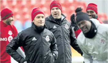  ?? NATHAN DENETTE/THE CANADIAN PRESS ?? Toronto FC head coach Greg Vanney, centre, jokes around during practice Friday at BMO Field in Toronto ahead of Saturday’s MLS Cup final rematch against the Seattle Sounders.