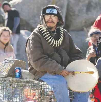  ?? MARK O'NEILL / THE CANADIAN PRESS ?? A member of the Sipekne'katik First Nation sits on a lobster trap in Saulniervi­lle, N.S., on Sunday.