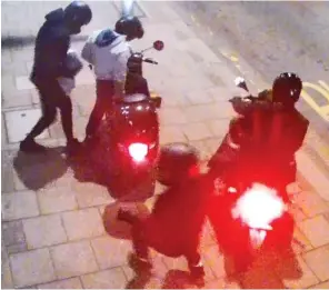  ??  ?? Brazen: The four moped raiders help themselves to expensive perfumes at the branch of Boots in north London… before loading up and making their getaway