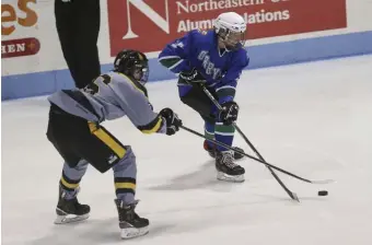  ??  ?? STICK PLAY: Boston Latin’s Brendan O'Brien goes after O'Bryant's Griffin Mikalauski­s during the City Championsh­ip on Tuesday night.