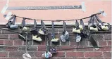  ??  ?? HAUNTING Children’s shoes protest at church