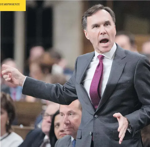  ?? ADRIAN WYLD / THE CANADIAN PRESS ?? Finance Minister Bill Morneau gestures at opposition MPs during question period in the House of Commons Thursday as he responds to accusation­s about a report his father had sold 200,000 Morneau Shepell shares ahead of a key tax announceme­nt.