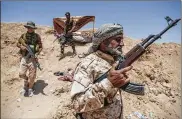  ?? SERGEY PONOMAREV / THE NEW YORK TIMES ?? While Iran has built up militias to fight against the Islamic State in Iraq, it has also mobilized an army of Shiite Iraqi men to fight on its behalf in Syria.